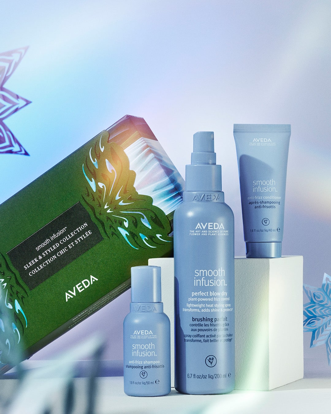 Aveda Smooth Infusion Haarpflegeset vor einem hellen, dekorativen Hintergrund. Enthält Perfect Blow Dry, ein glättendes Serum, einen kleinen Artikel in Reisegröße und eine stilvolle Verpackung mit blauen und grünen Akzenten. Aveda Smooth Infusion Haarpflegeset vor einem hellen, dekorativen Hintergrund. Enthält Perfect Blow Dry, ein glättendes Serum, einen kleinen Artikel in Reisegröße und eine stilvolle Verpackung mit blauen und grünen Akzenten.